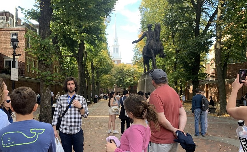 Nabil guiding a group along Boston's Freedom Trail near the Paul Revere statue